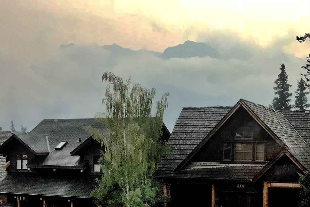 The mountains surrounding Canmore, Alta., are obscured by the smoky haze from the outbreak of western wildfires in British Columbia and Alberta this summer. (Photo: Robert Sandford)